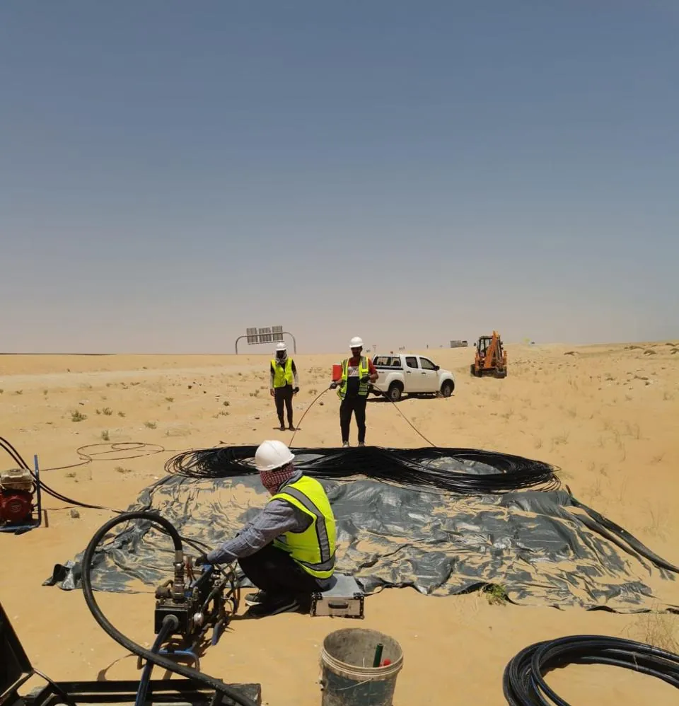 Fiber cable drums and splicing work at a desert field site